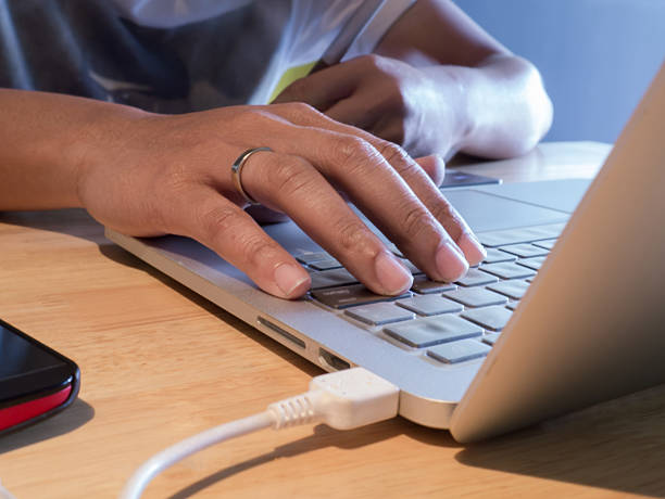 istock Man hands using laptop on wooden desk. 496543856