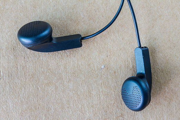 istock Earphones on wood background 496546652