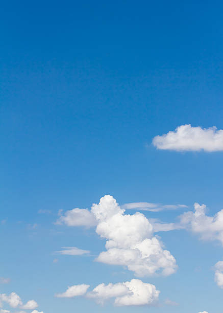 istock blue sky with cloud closeup and bright sun, vertical cloud 496547968