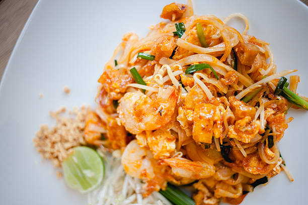 istock Delicious rice noodles with shrimp close-up on a plate. horizontal 496548084