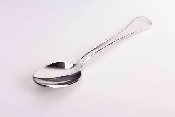 istock Stainless steel kitchen dessert spoon isolated over the white background 496548402