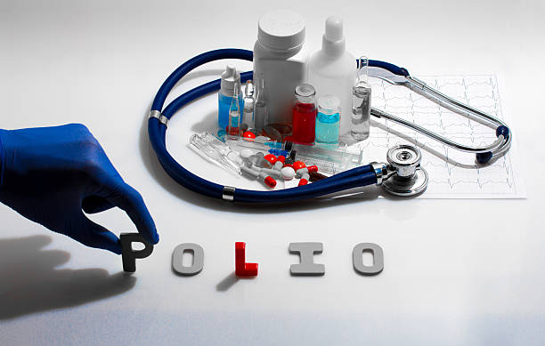 Polio Diagnosis - Polio. Medical concept with pills, injection, stethoscope, cardiogram and a syringe polio virus photos stock pictures, royalty-free photos & images