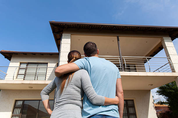 istock young couple looking at their new house 496550250