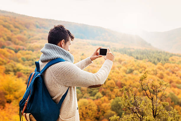 istock Handsome young man in autumn nature 496550410