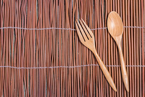 istock Spoon and Fork Wood Kitchware on Willow Branch Mat 496551820