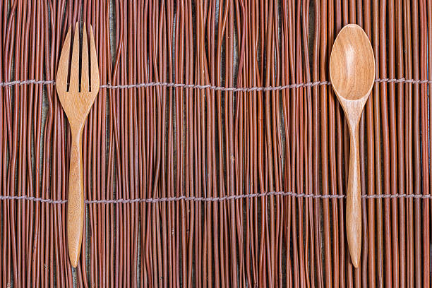 istock Spoon and Fork Wood Kitchware on Willow Branch Mat 496551954