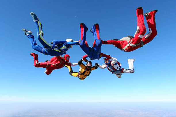 Skydiving photo. Building a group of paratroopers ring in free fall. skydiving stock pictures, royalty-free photos & images