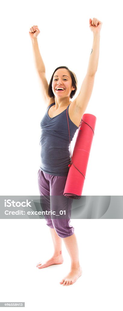 Young woman carrying exercise mat celebrating success 25-29 Years Stock Photo