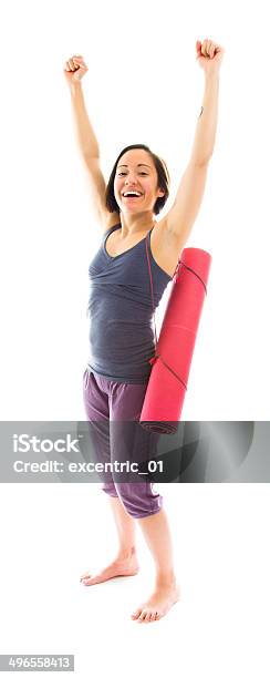 Young Woman Carrying Exercise Mat Celebrating Success Stock Photo - Download Image Now