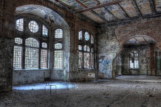 Old abandoned hospital Abandoned room with a bed and chairs beelitz stock pictures, royalty-free photos & images