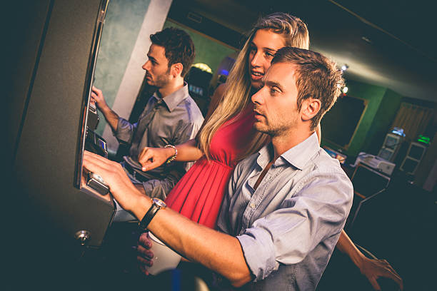 istock Young couple gambling on slot machines 496560023