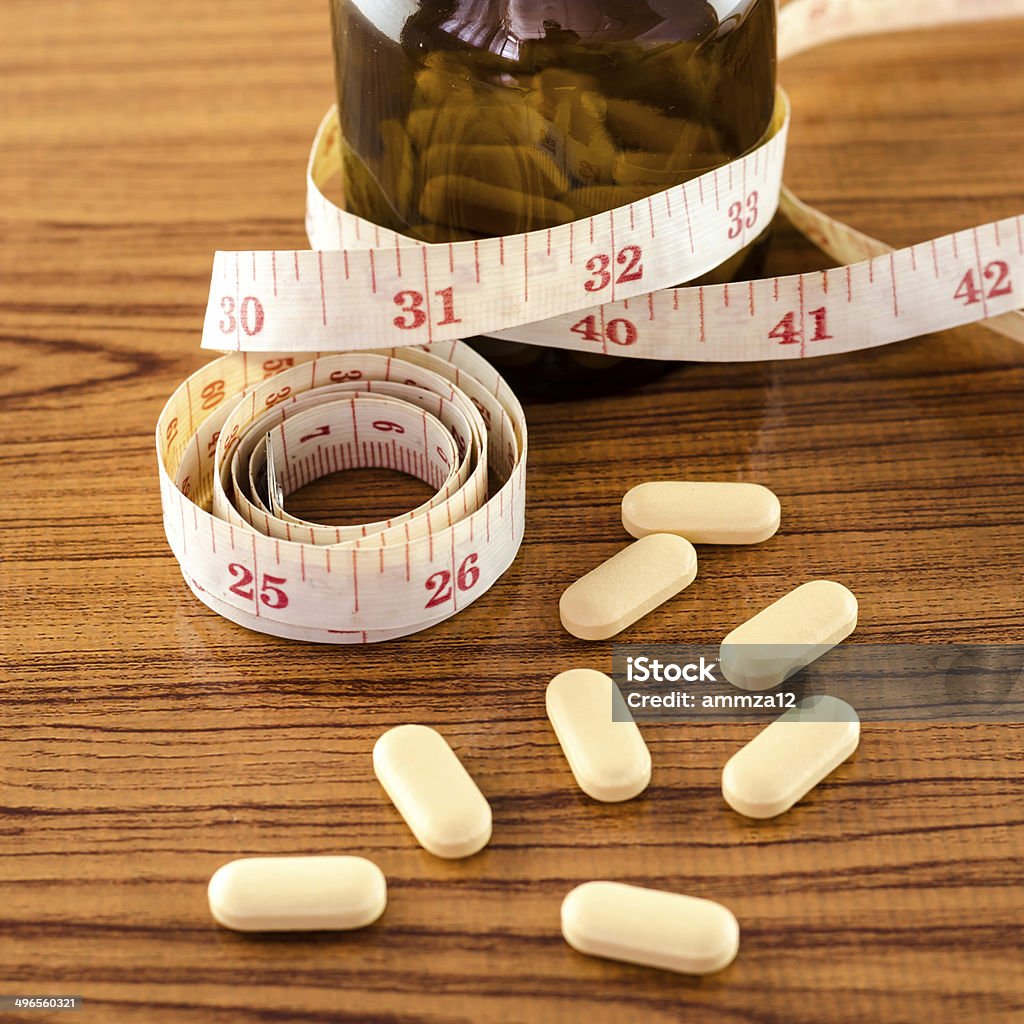 pills and measuring tape pills and measuring tape concept diet with drug Backgrounds Stock Photo