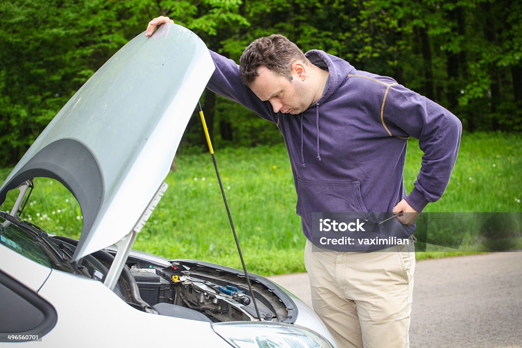 Car problem Driver have a problem and he is looking under the hood to find what is wrong. Will he make it? Adult Stock Photo