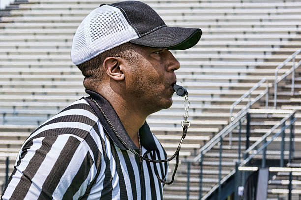 istock Football Referee Blows His Whistle 496563165