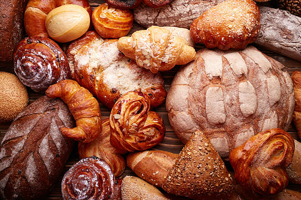 Bread and buns Fresh tasty bread and buns over wooden background bakery stock pictures, royalty-free photos & images