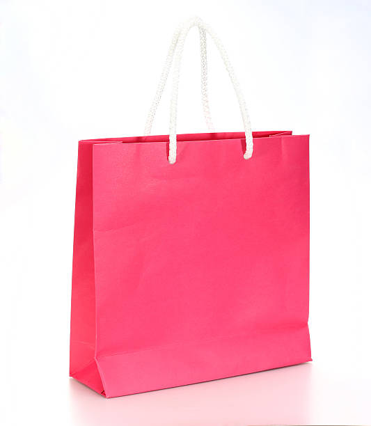 istock Pink shopping paper bag isolated on a white background 496565475
