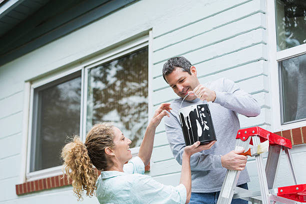 Couple Painting House Exterior