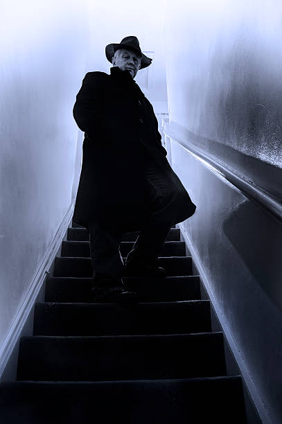 istock Mysterious man in black stands on stairwell 496566371