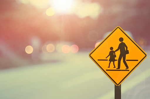 School sign.Traffic sign road on blur road abstract background.Retro color style.