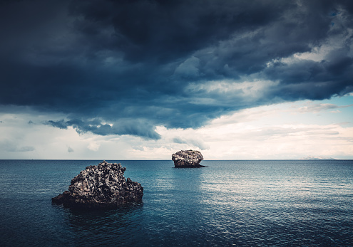 Two lonely rocks in the sea (Kefalonia, Greece). The storm is aproaching to the beach.