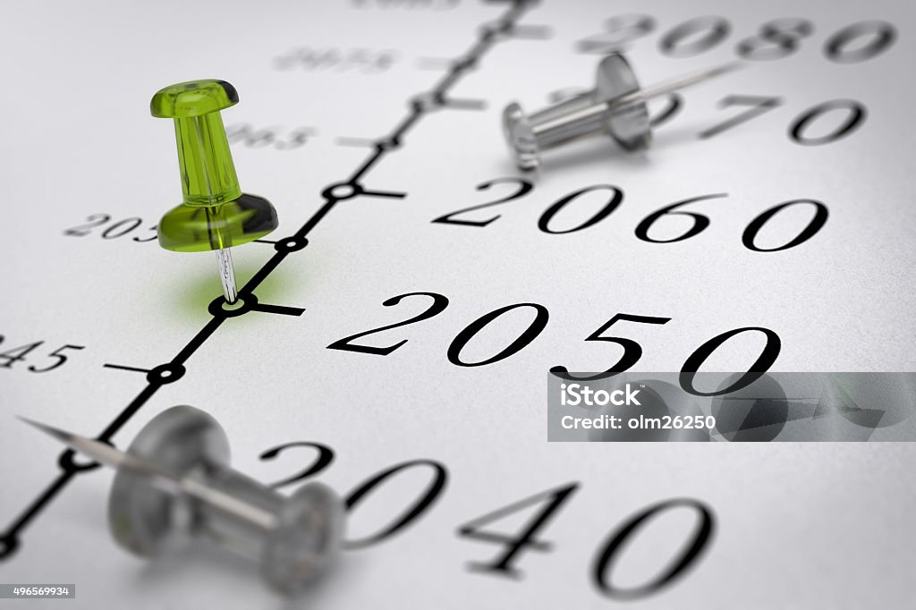 21st Century Timeline, year 2050. 21st Century timeline over paper background with green pushpin pointing the year 2050, blur effect, conceptual image. Planning Stock Photo