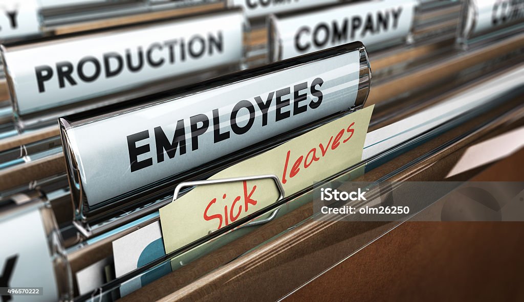 Sick Leave Close up on a file tab with the word employees plus a note with the text sick leaves, blur effect at the background. Concept image for illustration of sick leave entilement. Sick Leave Stock Photo