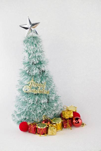 istock Mini christmast tree with glittering white background. Christmas theme 496575240