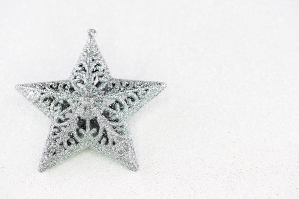 istock Silver christmas star with glittering white background. 496575940