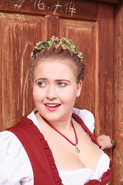 istock young woman in dirndl  and elaborate hairstyle 496577510