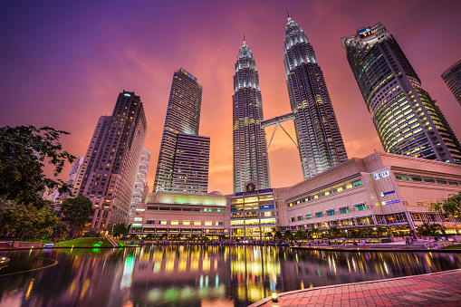 Kuala Lumpur, Malaysia - September 20, 2015: KLCC Park and Petronas Twin Towers at sunset. They are the tallest Twin Towers in the World.