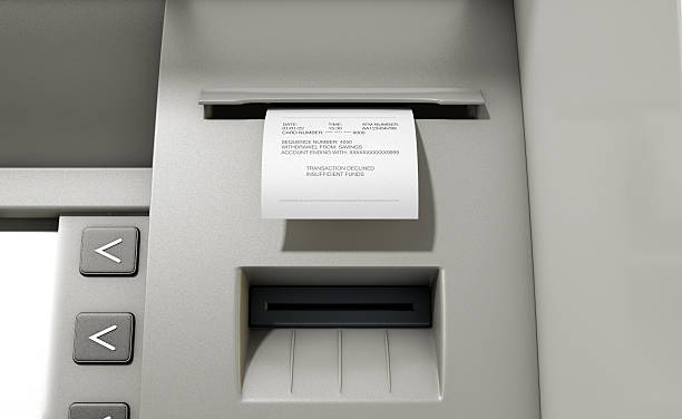 ATM Slip Declined Receipt A closeup view of the slip printing section of an atm with a declined receipt insufficient funds stock pictures, royalty-free photos & images