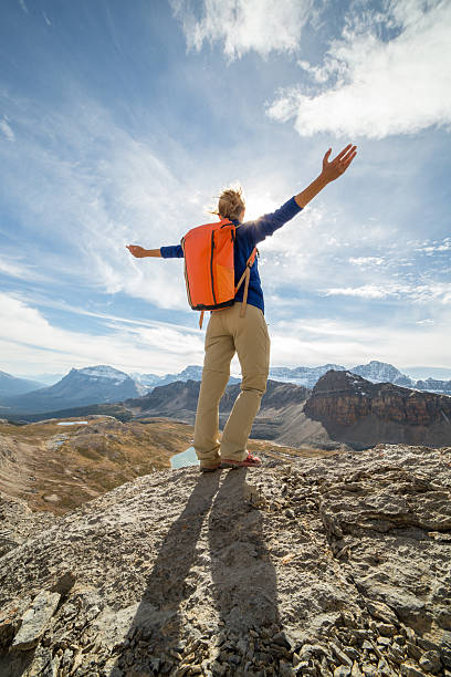 istock Cheering woman celebrating on mountain top 496577940