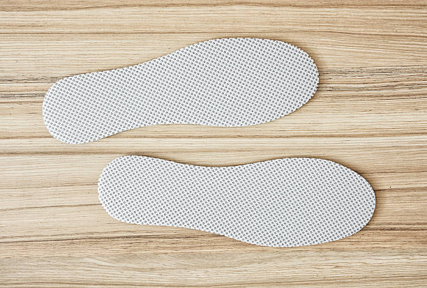 Shoe insoles on the wooden background stock photo