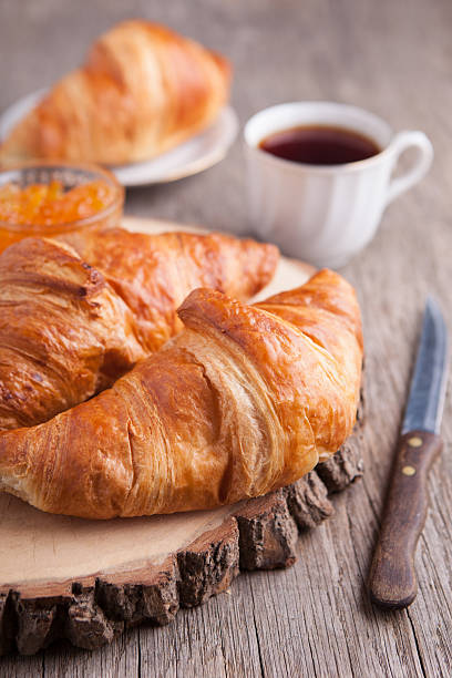 istock Three croissants on the dark wooden table 496580966
