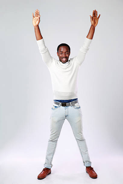 istock portrait of african man with raised hands 496583521