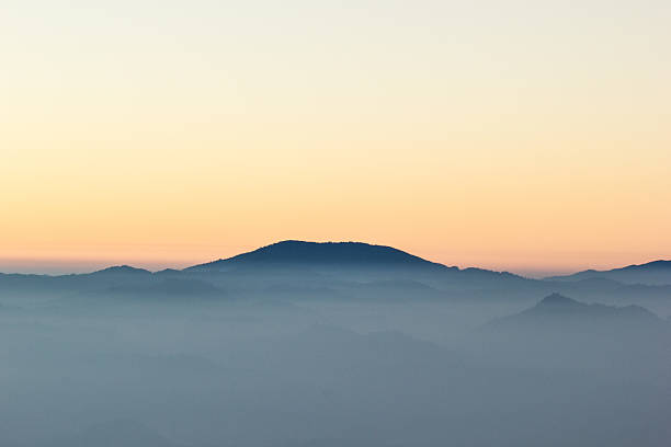 istock morning mist cover tree and mountain 496584219