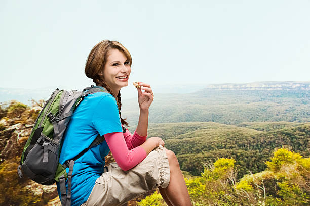istock Smiling hiker eating protein bar 496585419