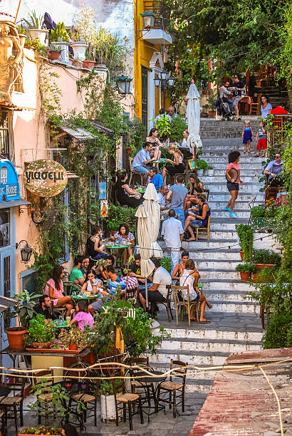 Plaka Athens, Greece - August 2, 2012: People dining outside on the stairs in the Plaka district of Athens. plaka athens stock pictures, royalty-free photos & images