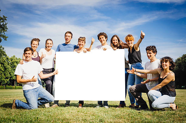 istock Goup of friends holding a billboard for copy space 496587485