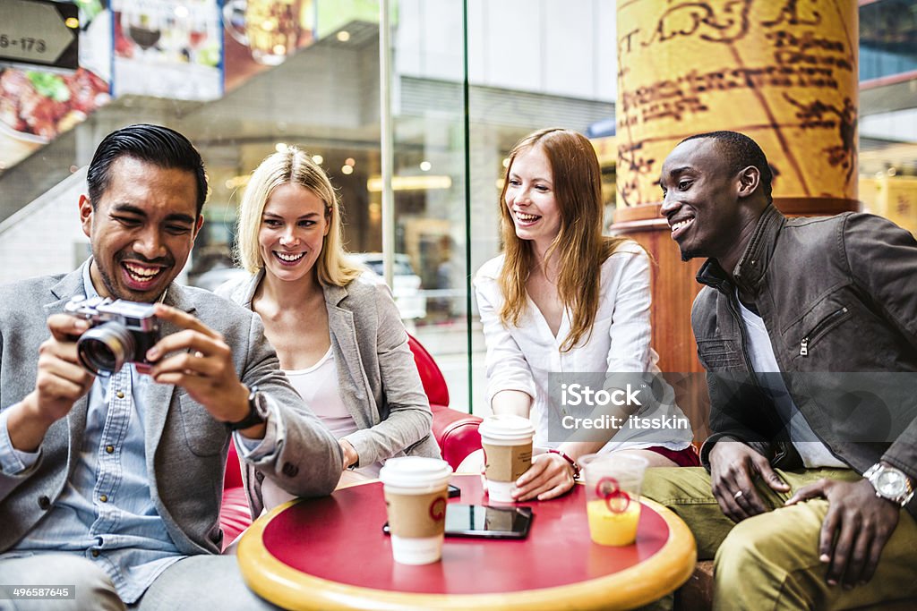 Four friends in Hong Kong cafe Four friends in Hong Kong cafe  Adult Stock Photo