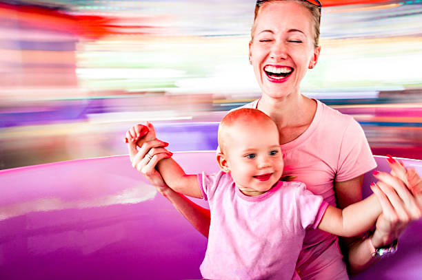 Mother and daughter in amusement park stock photo