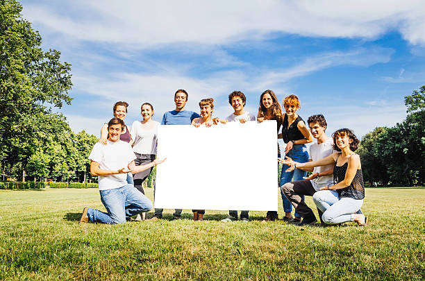 istock Goup of friends holding a billboard for copy space 496587829