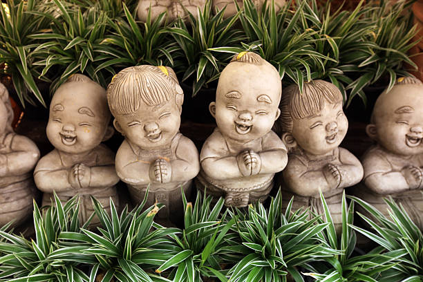 Small figures in a garden of Old Sukhothai in the province of Sukhothai in the north of Thailand in South East Asia.