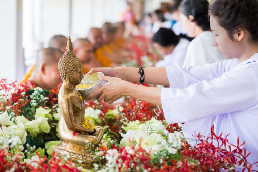 rayong, thailand - april 20,2014 : many people water pouring to hands monk in Songkran festival at ta khan temple.