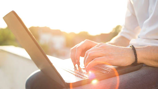 istock Hand typing on a laptop in sunset 496597095