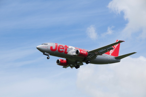 Jersey, U.K. - June 7, 2014: Jet2 a British budget company flying a commercial Boeing 737-300 jet, a nationwide airliner, landing at Jersey airport.