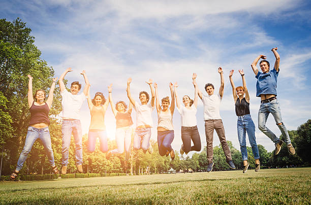 istock Group of friends jumping in the park 496598037