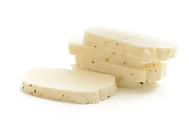 Halloumi cheese slices isolated on a white background.