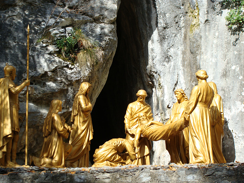 Jesus at tomb statue in sunshine day, Lourdes, France