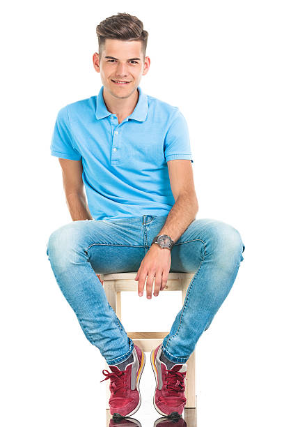 istock young casual man sitting on a chair. 496601762